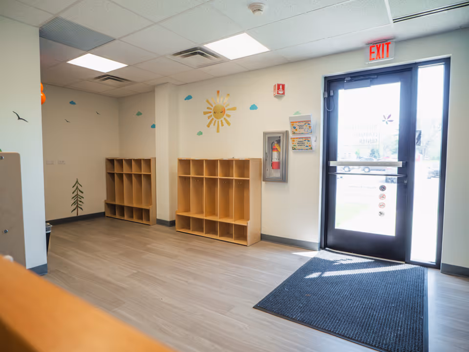 Bright front lobby of Total Spectrum ABA with cubby shelves and exit door.