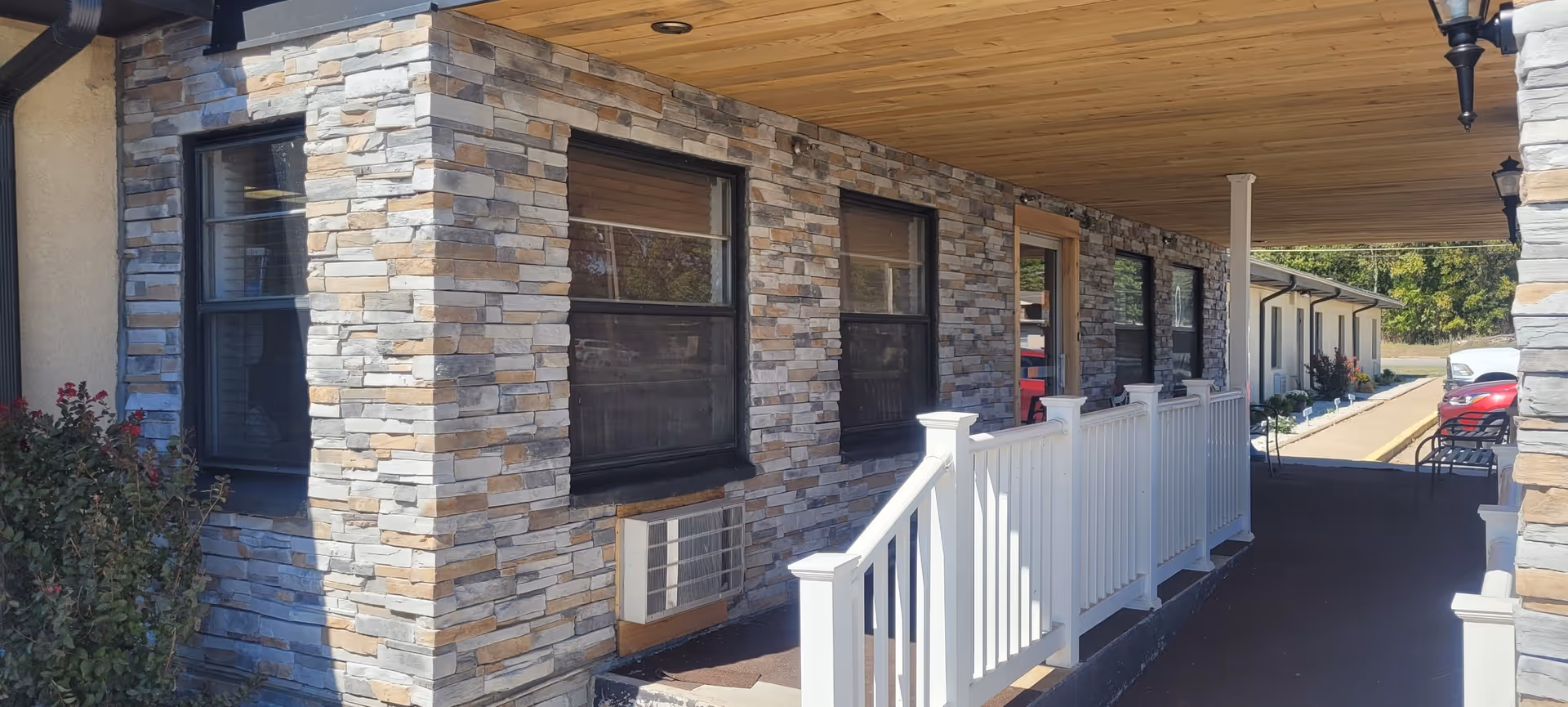 Exterior view of Hays House facility with stone walls and white railing