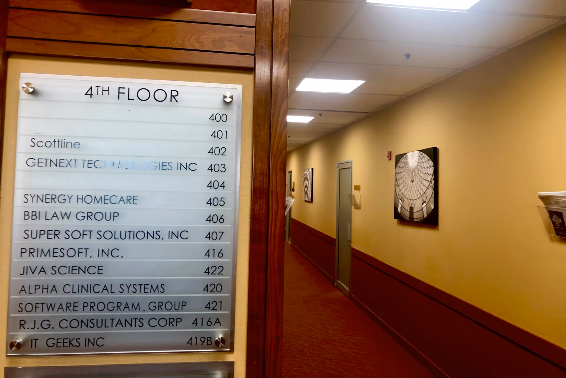 Interior hallway with a directory sign listing SYNERGY HomeCare among other offices.