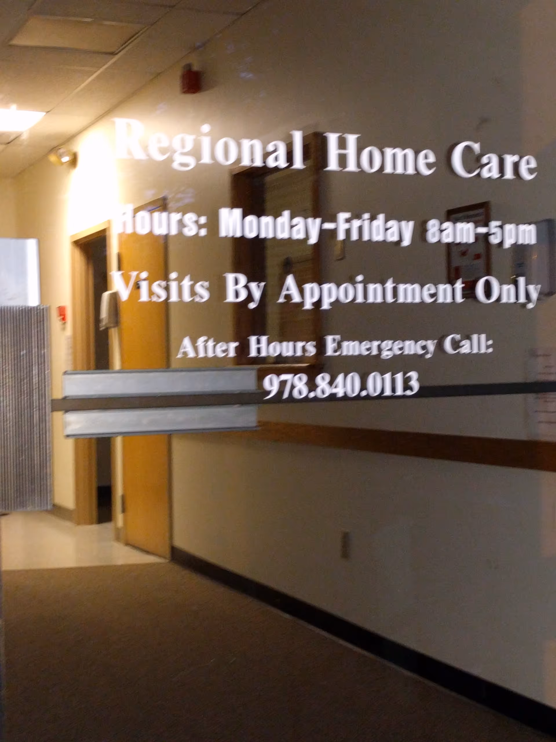 Interior hallway with glass door displaying Regional Home Care hours.