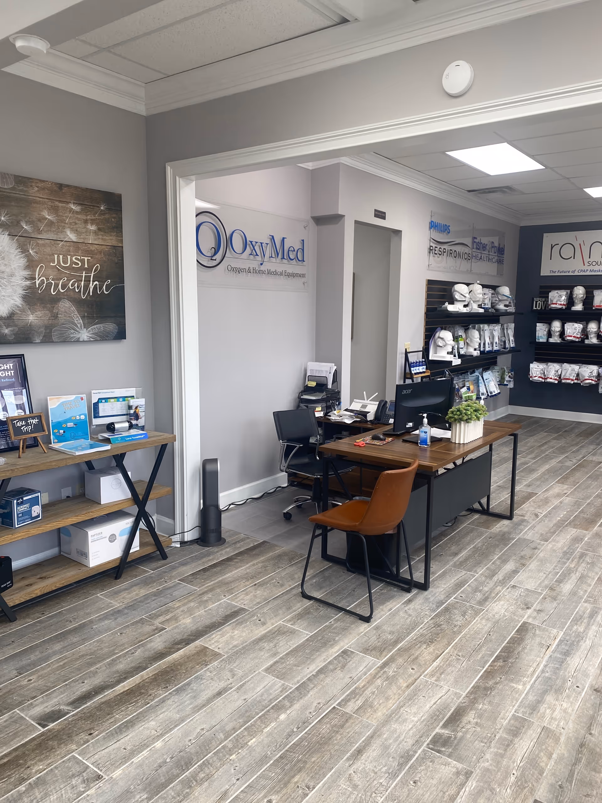 Interior reception area of OxyMed CPAP with desk, seating, and product displays