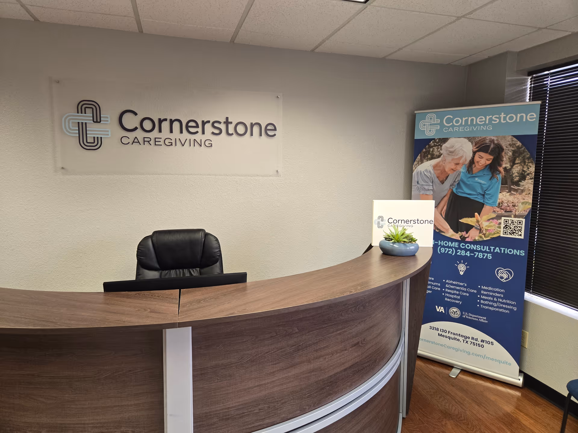 Reception desk with Cornerstone Caregiving sign and promotional banner inside.