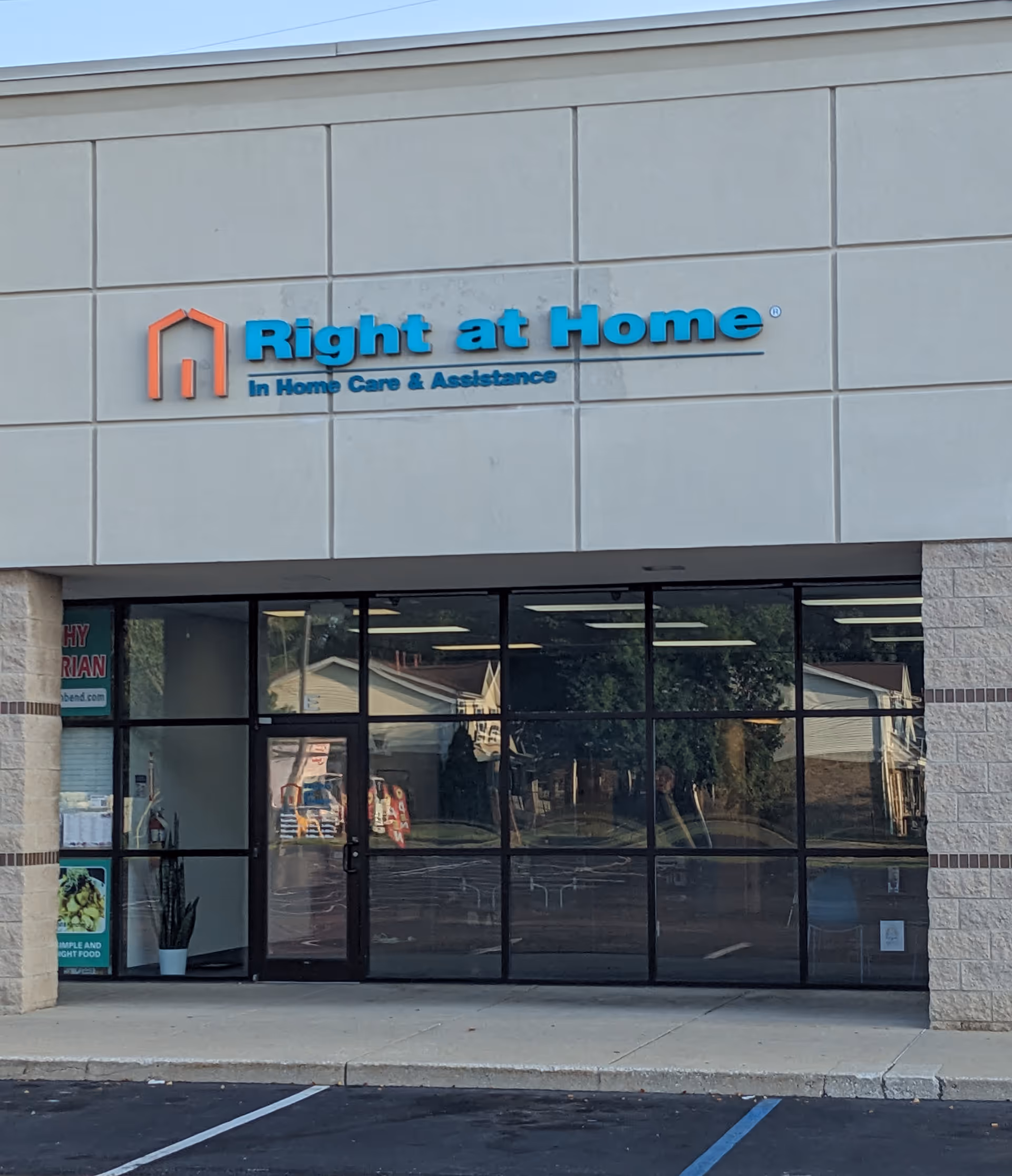 Right at Home storefront on building exterior with glass entrance doors.