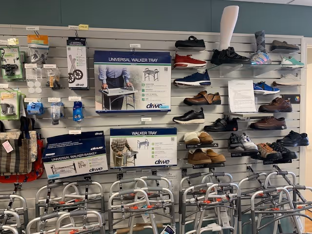 Wall display of mobility aids including walkers and shoes in a retail area.