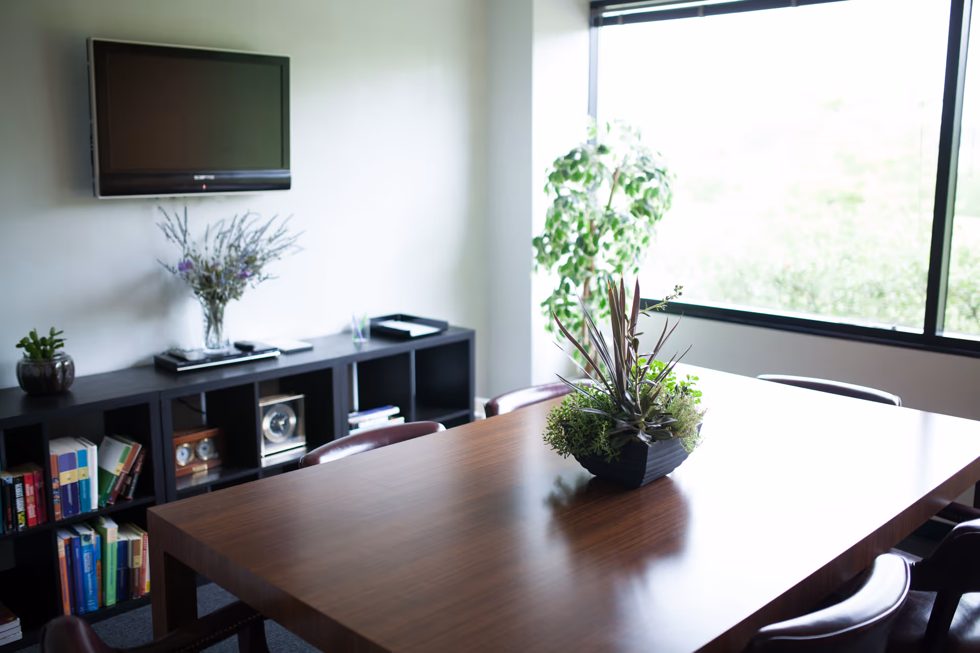 A modern interior living room at Lavender Home Care Solutions with a wooden table and plants.