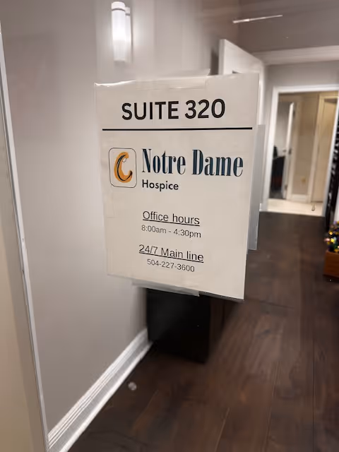 Interior hallway featuring a Suite 320 sign for Notre Dame Hospice.