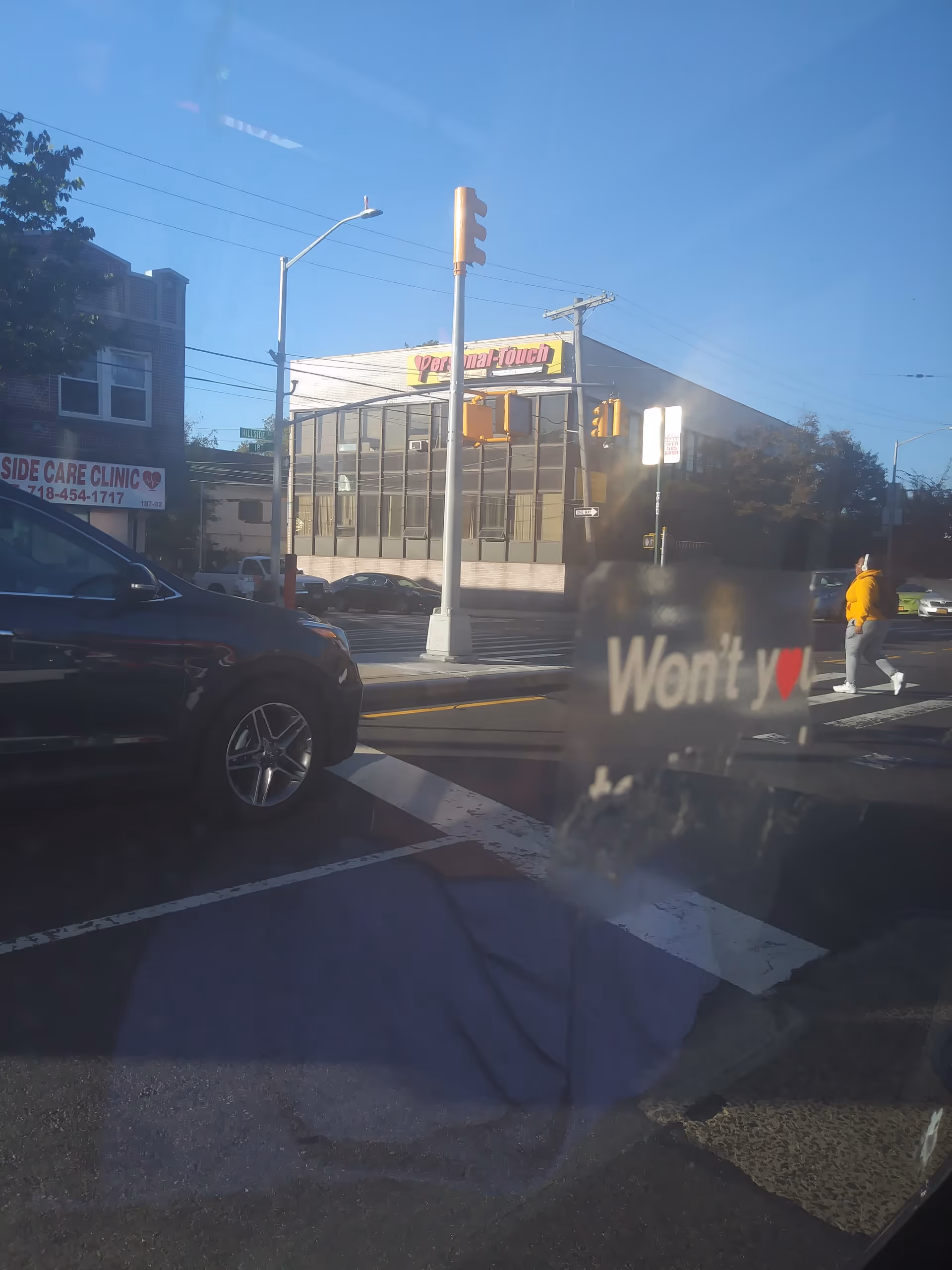 Street intersection with crosswalk in front of a building labeled Personal-Touch Home Care.