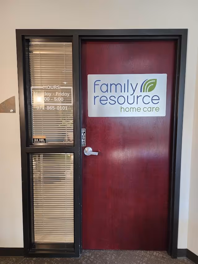 Maroon door with Family Resource Home Care sign beside a windowed entry panel.