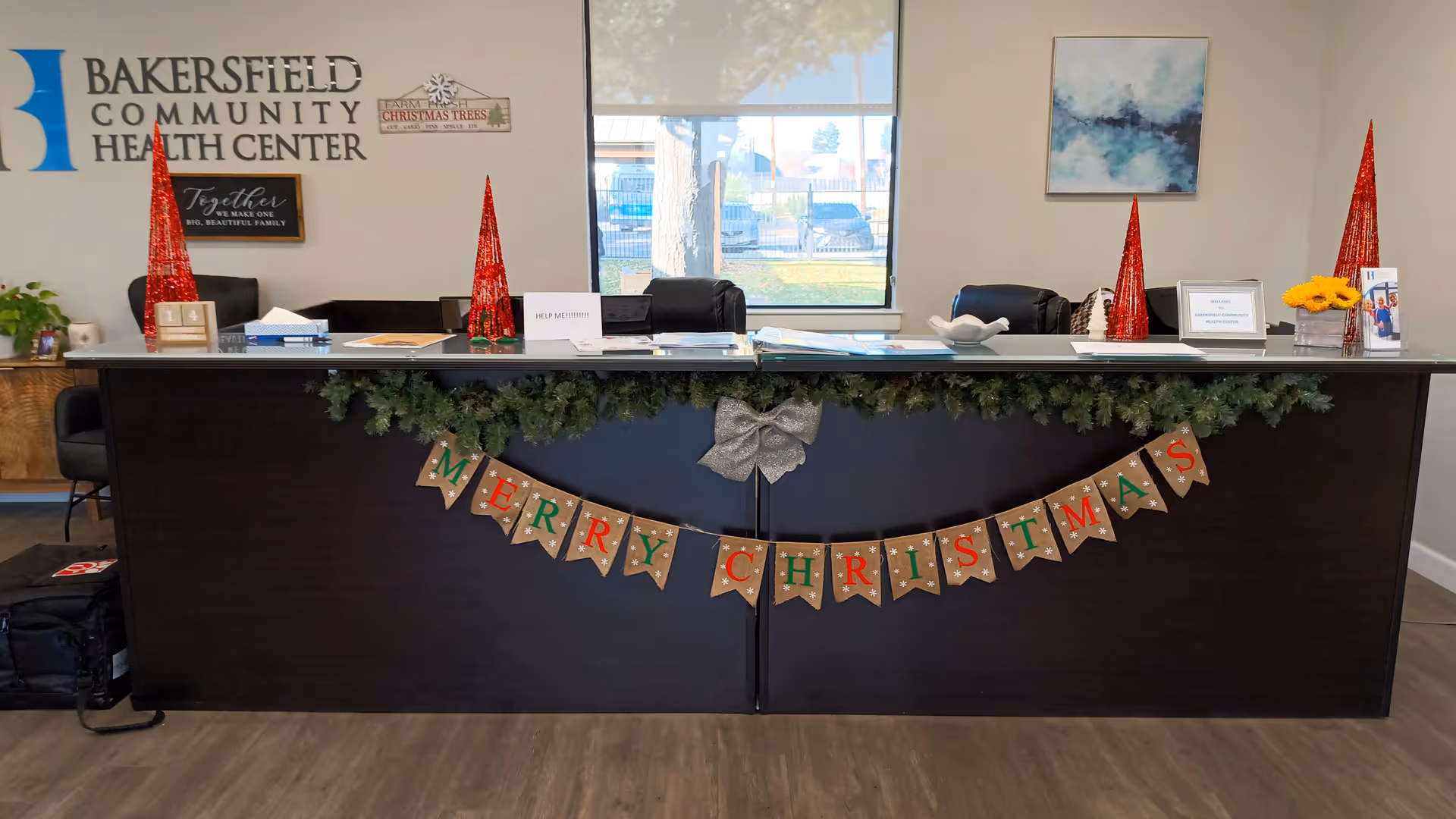 Reception desk inside Bakersfield Community Health Center decorated for Christmas.