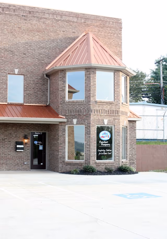 Brick exterior of Comfort Keepers facility with bay windows and front entrance