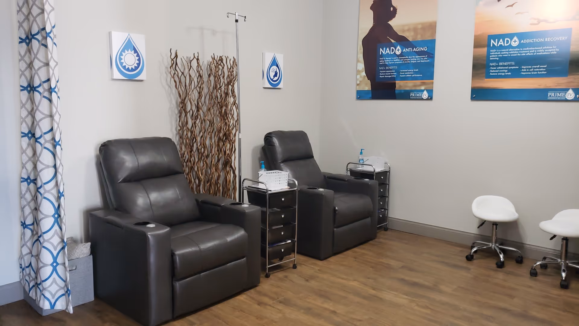 Infusion chairs with carts and IV stands in a clean wellness lounge.