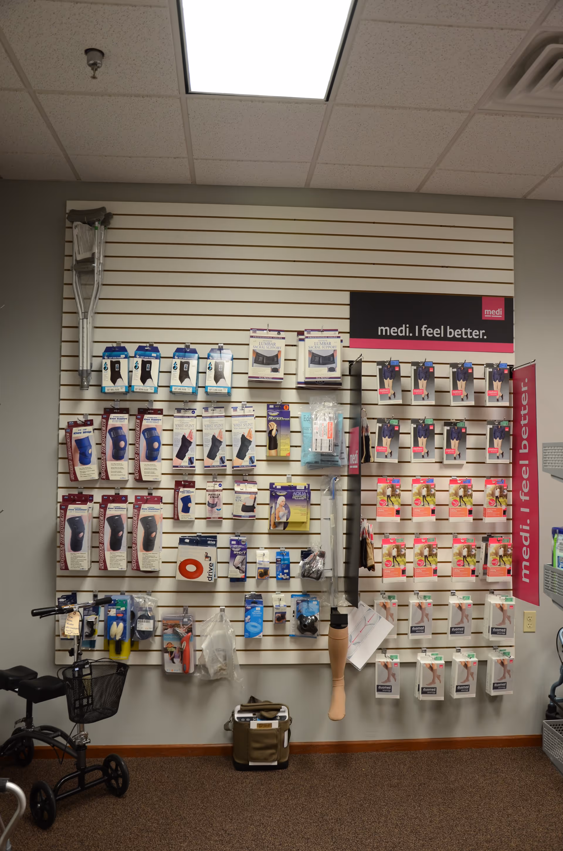 Wall-mounted medical supply display in an interior facility hallway.