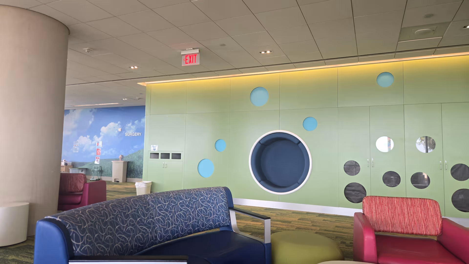 Vibrant pediatric clinic lobby with circular wall accents and contemporary seating.