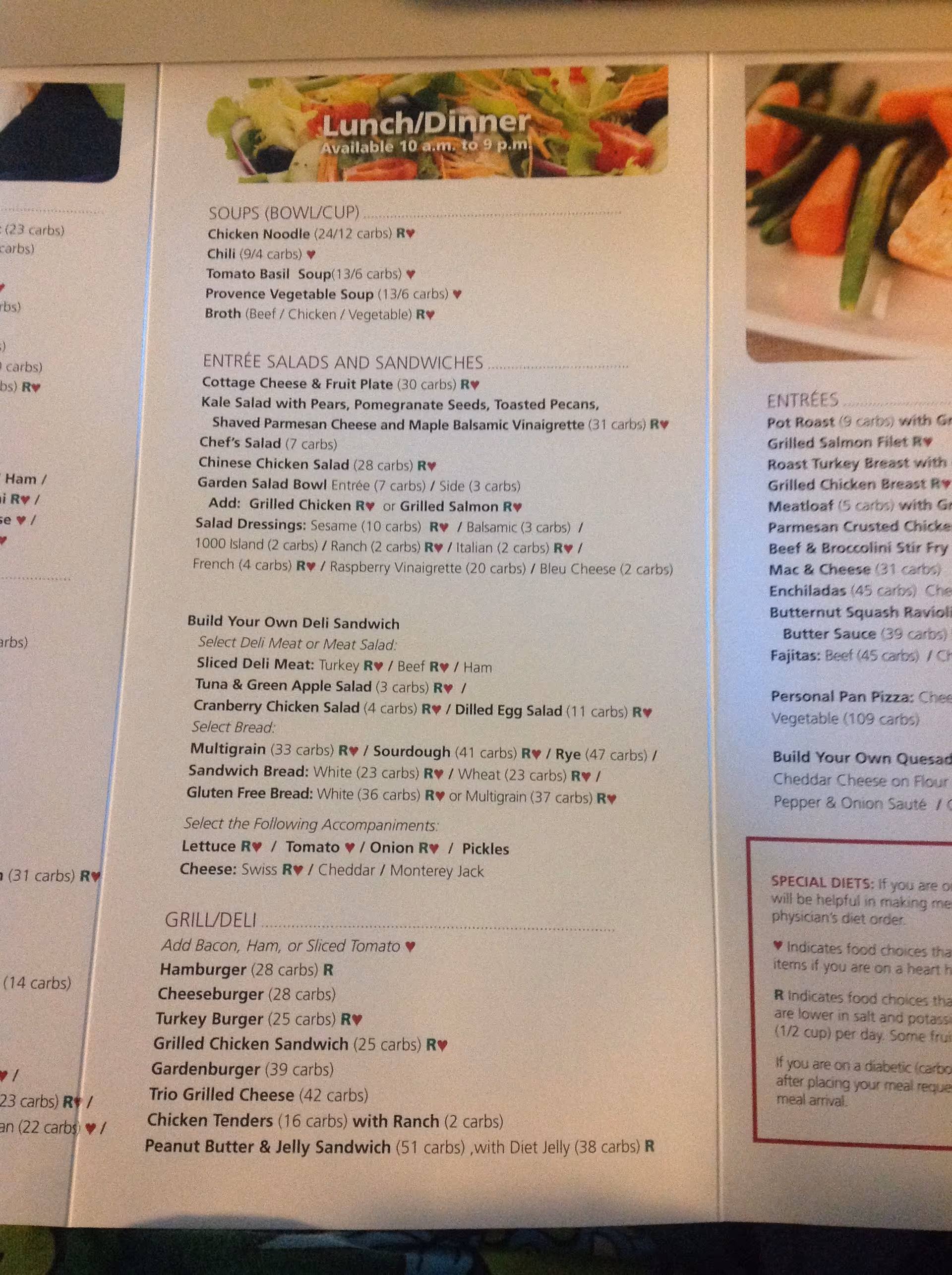 Close-up of dining menu board listing Lunch/Dinner items inside a facility.