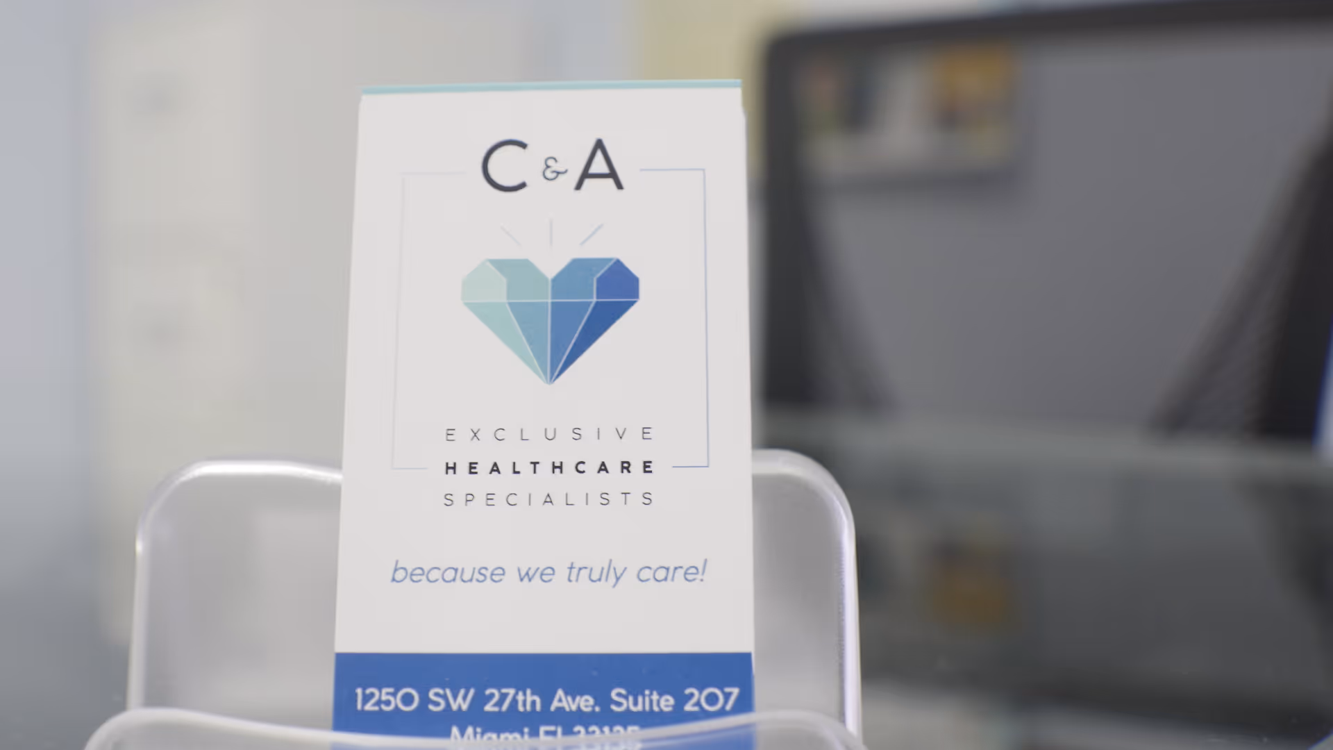 A C&A brochure stands on a reception desk with a heart logo.