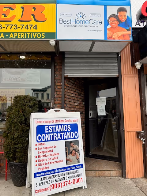 Storefront for Best Home Care Inc with a hiring sign outside brick facade.