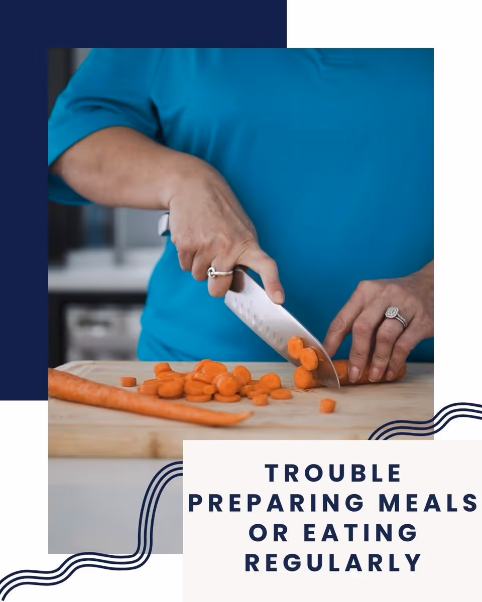 Person slices carrots on a cutting board in a kitchen.
