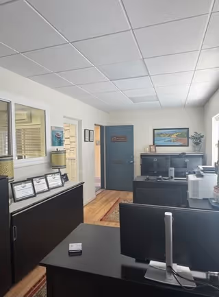 Office reception area in a Right at Home facility with desks and computers.