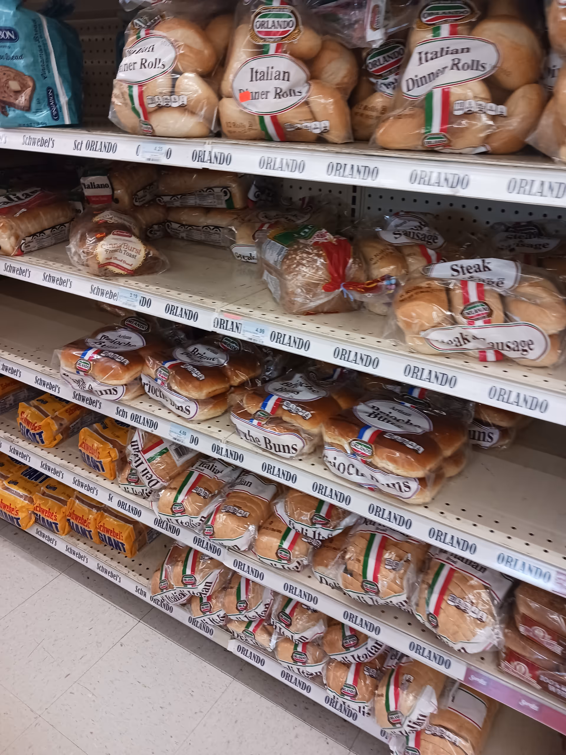 Aisle of assorted bread bags on shelves in Discount Drug Mart.