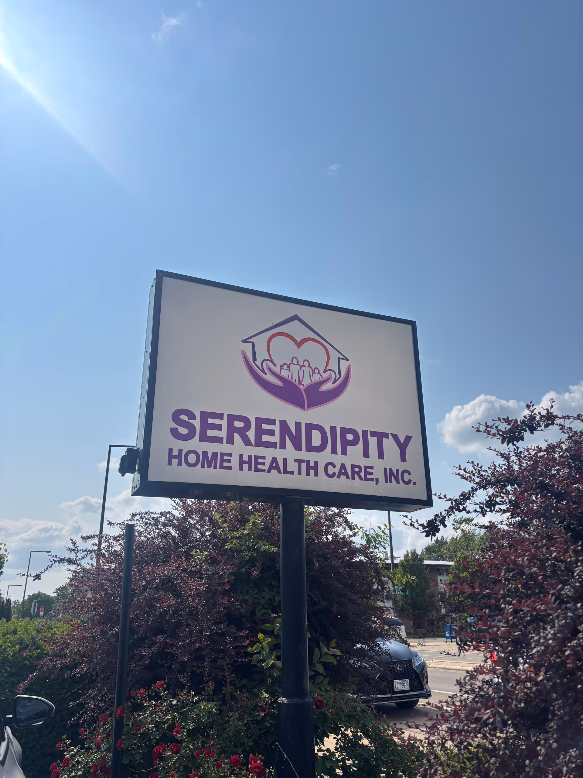 Outdoor sign for Serendipity Home Health Care, Inc. with blue sky and landscaping.