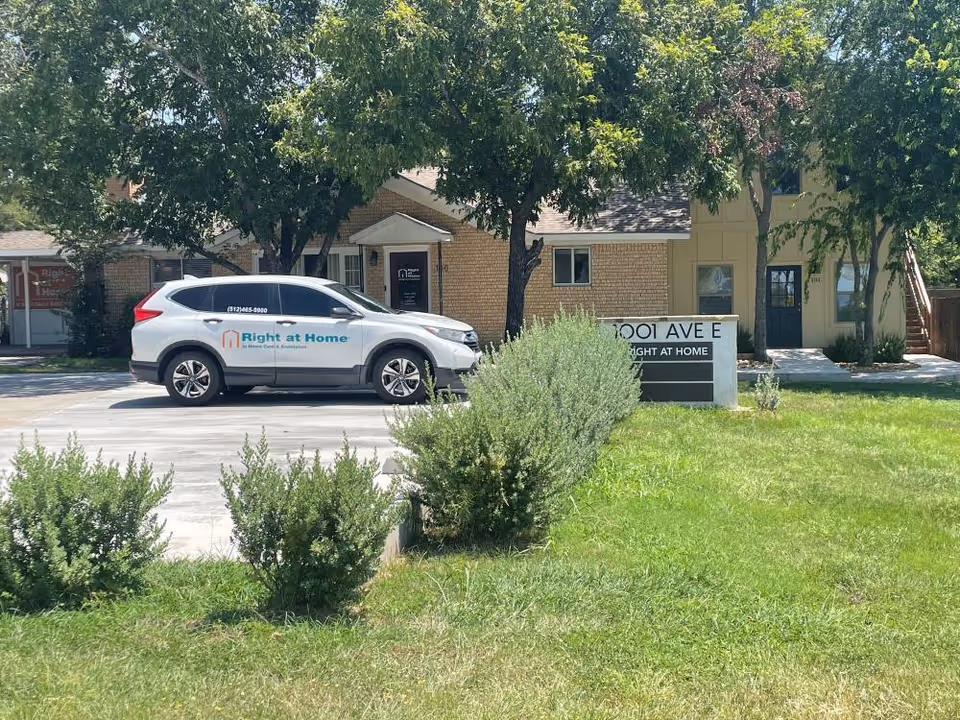 Exterior view of a Right at Home facility with a parked company vehicle.