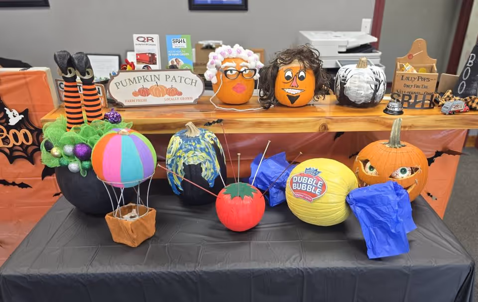 Colorful Halloween pumpkin decorations displayed on a table inside a senior care facility.