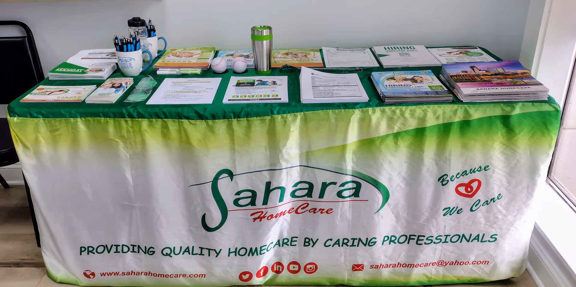 Display table with Sahara HomeCare brochures and promotional materials inside a facility.