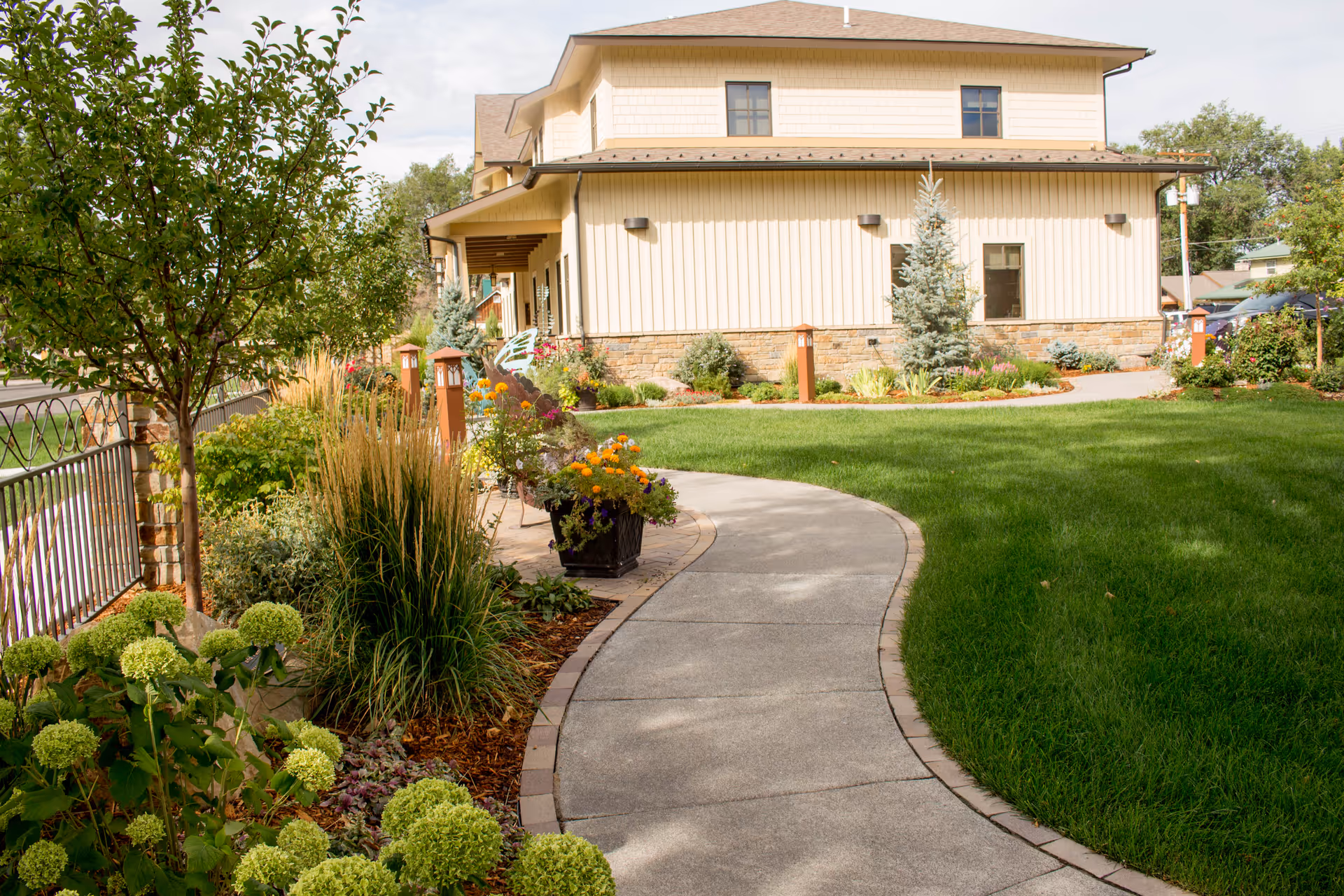 Exterior view of HopeWest Administrative Offices with curved walkway and manicured landscaping.