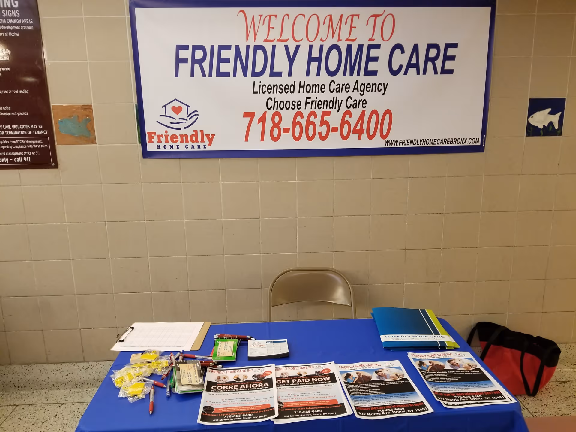 Indoor tiled lobby with a table of brochures under a Welcome to Friendly Home Care sign