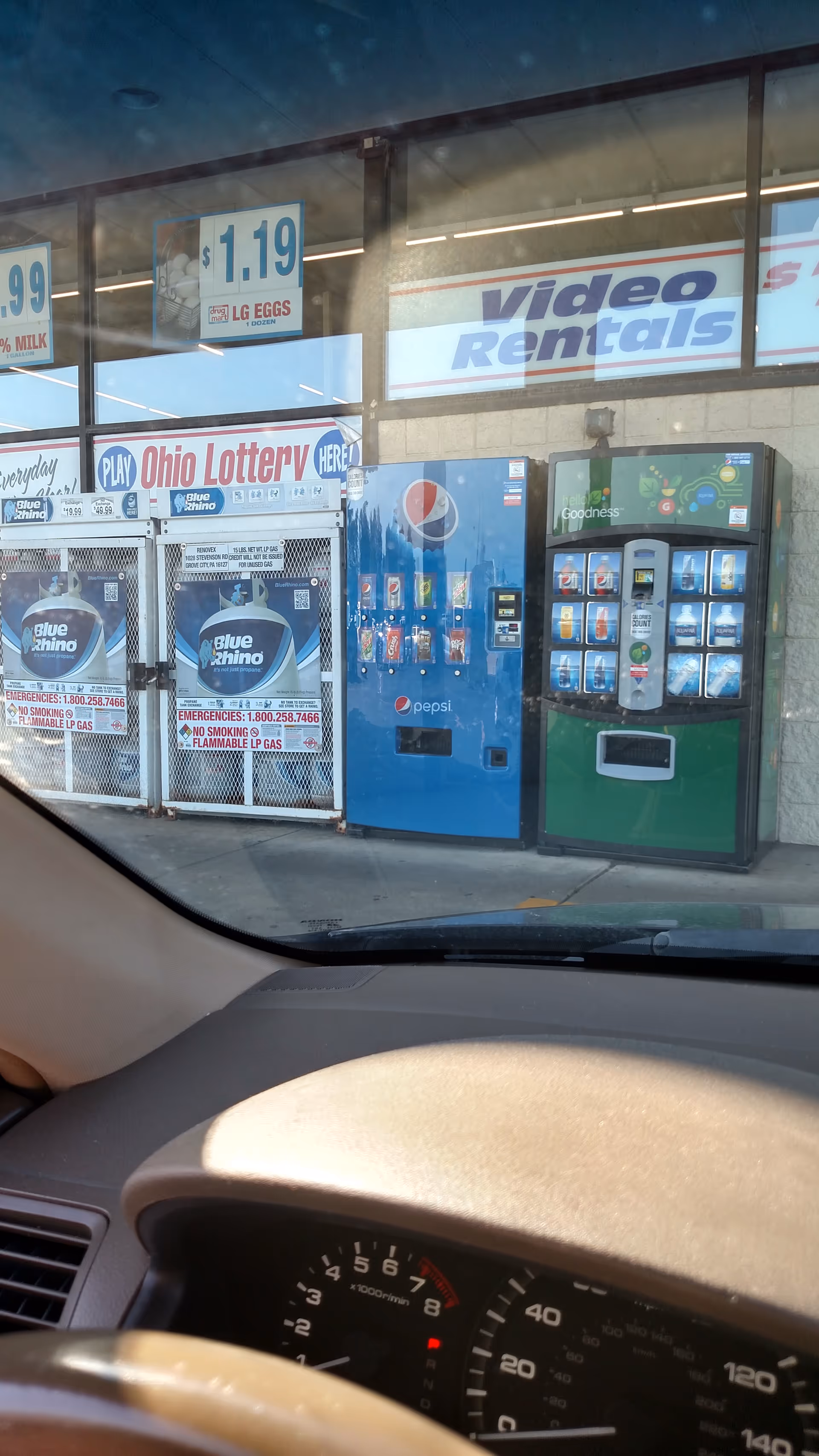 Exterior Discount Drug Mart storefront with vending machines and signage.