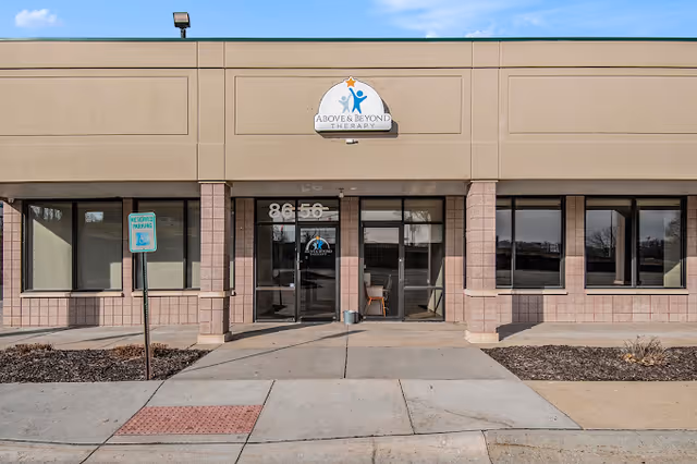 Front view of Above and Beyond Therapy Center building with glass doors and signage.