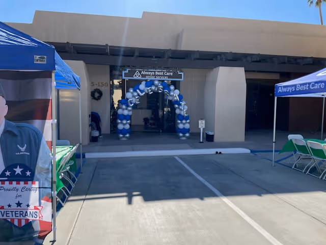 Entrance to Always Best Care facility with blue balloon arch and tents outside