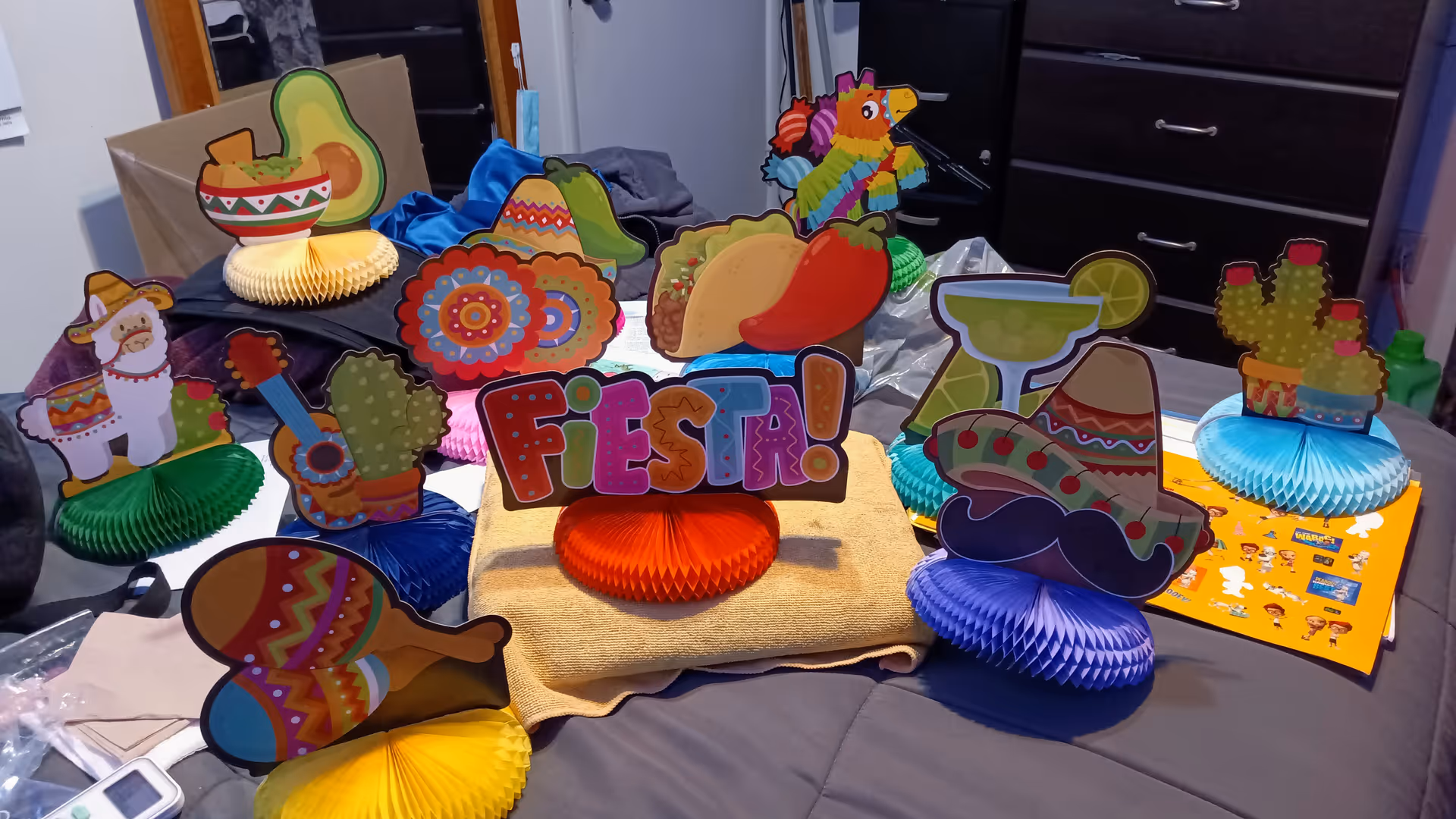 Colorful fiesta decorations arranged on a table inside an indoor room.