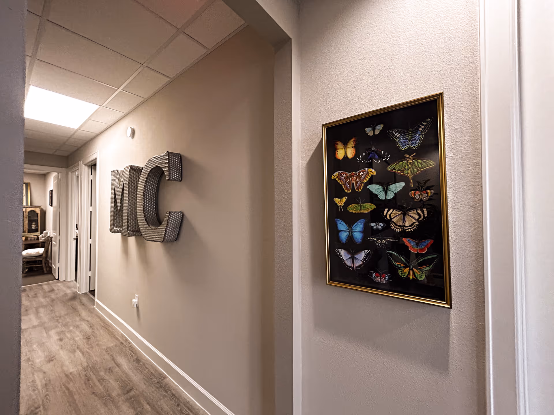 Long hallway in a care facility with butterfly artwork and MC letters
