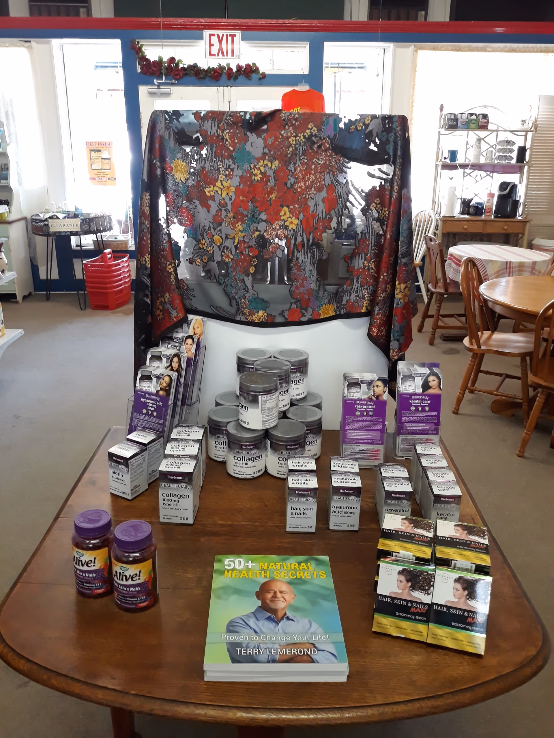 Indoor senior living common area with a table displaying health supplements and promotional booklets.