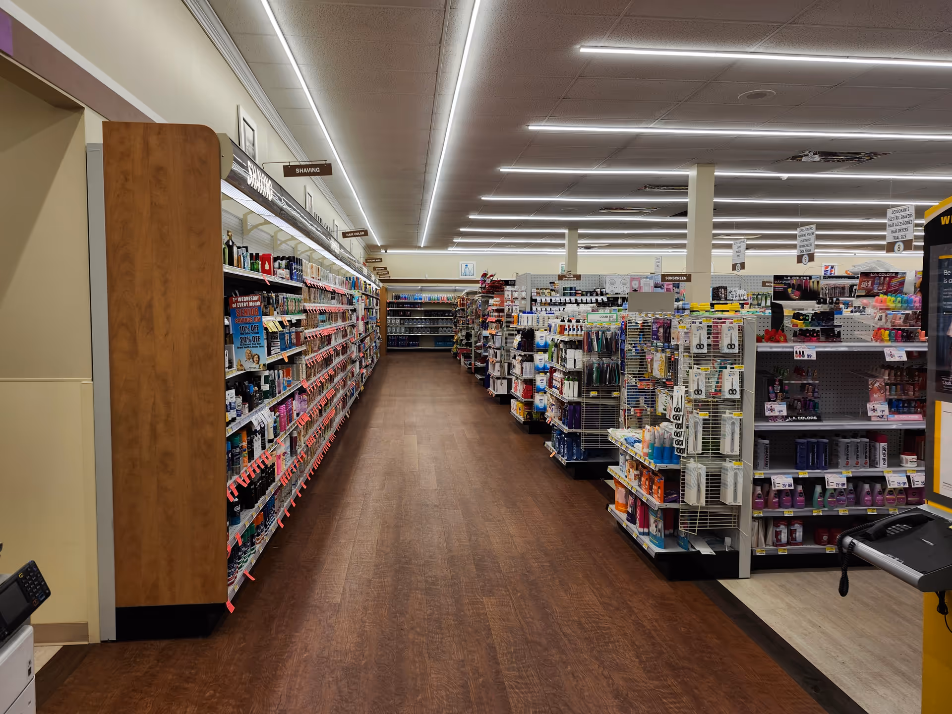 Indoor Discount Drug Mart aisle with tall shelves and merchandise on both sides.