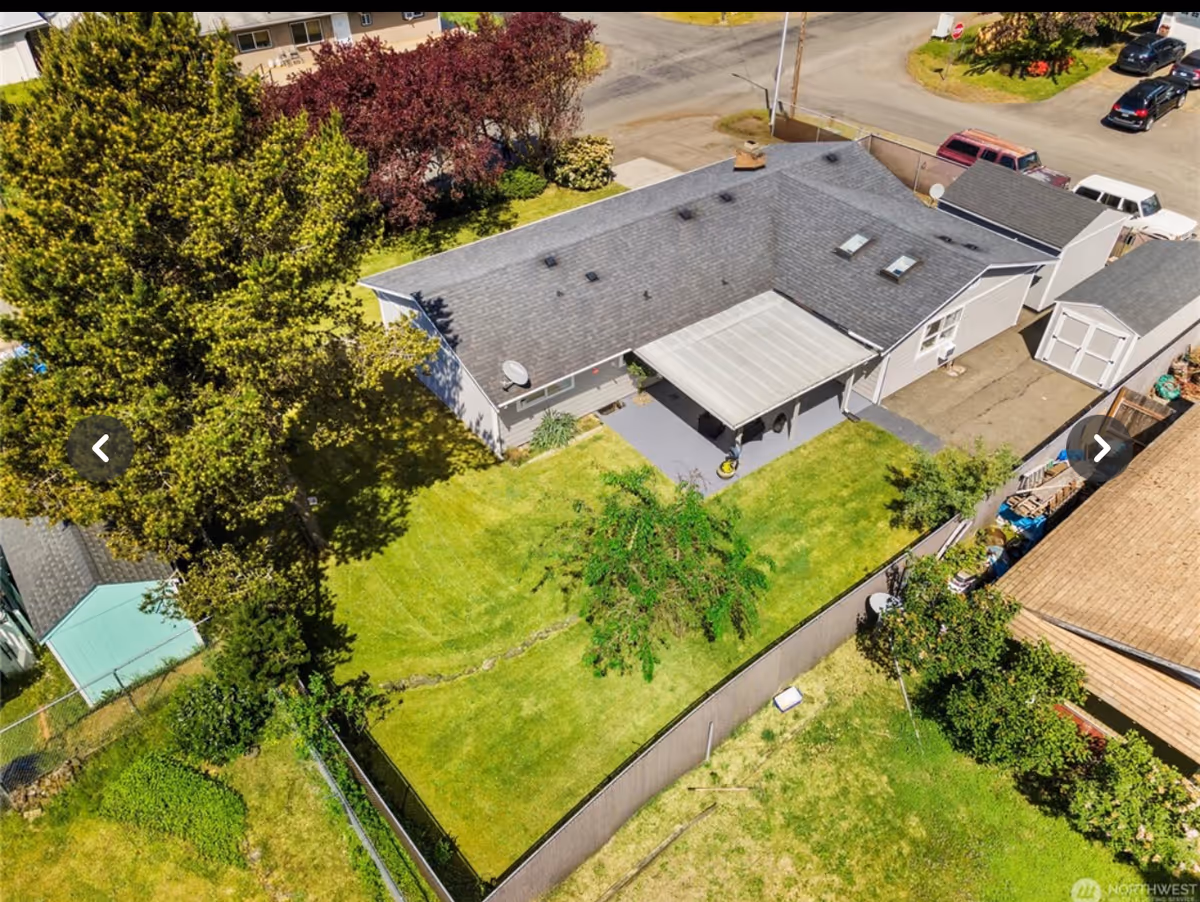Aerial view of Empathy Haven AFH LLC exterior with green lawn and fenced yard.
