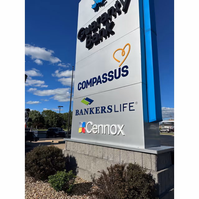 Tall outdoor sign for Compassus displaying Bankers Life and Cennox logos.