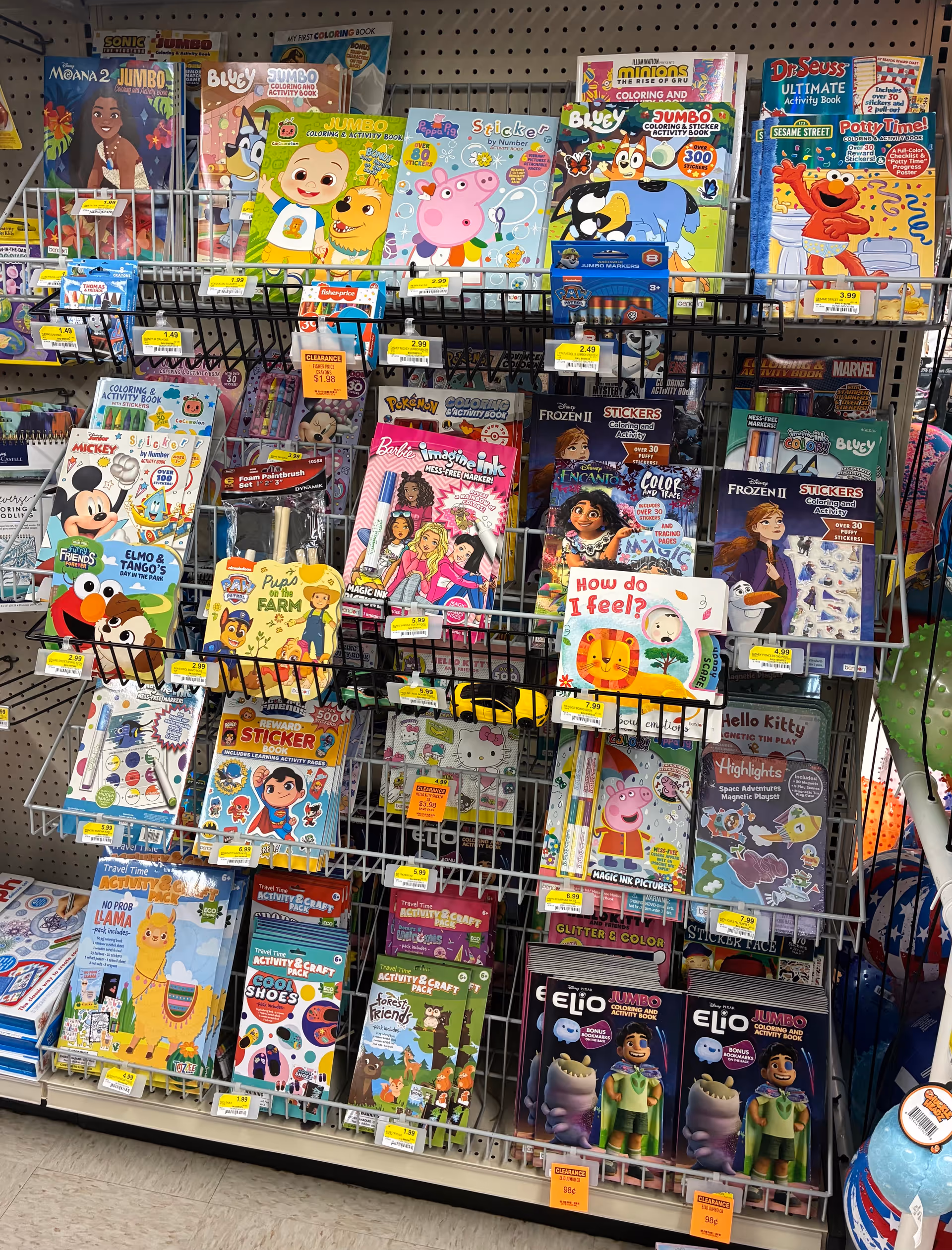 Metal display rack filled with colorful children's activity books in a Discount Drug Mart store.