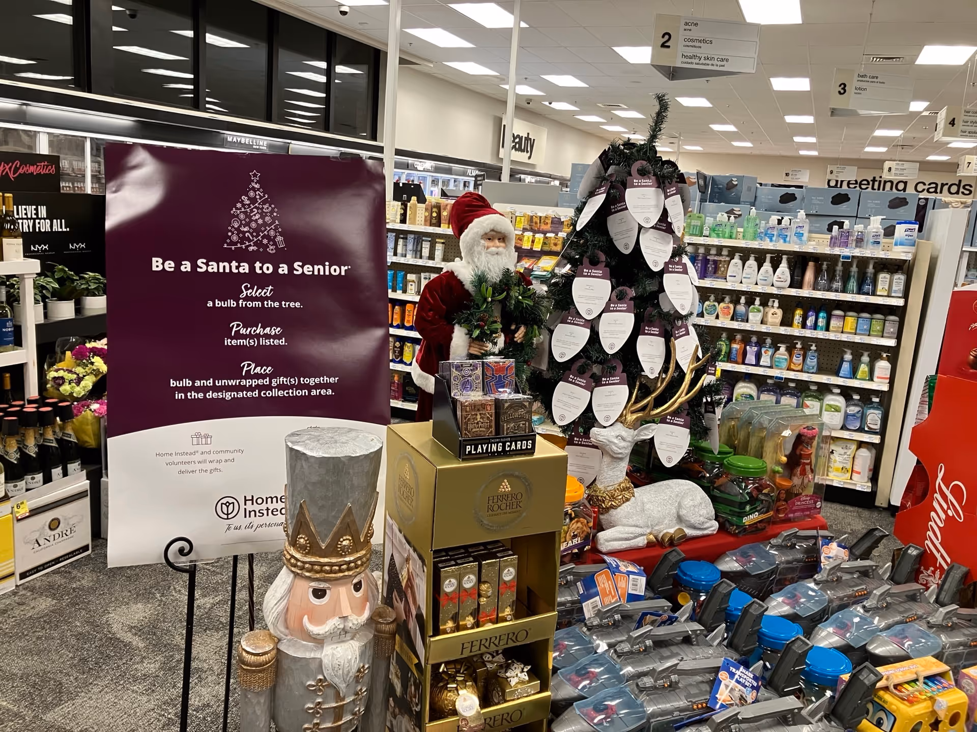 Santa display with tree and nutcracker among shelves in a well-lit indoor space.
