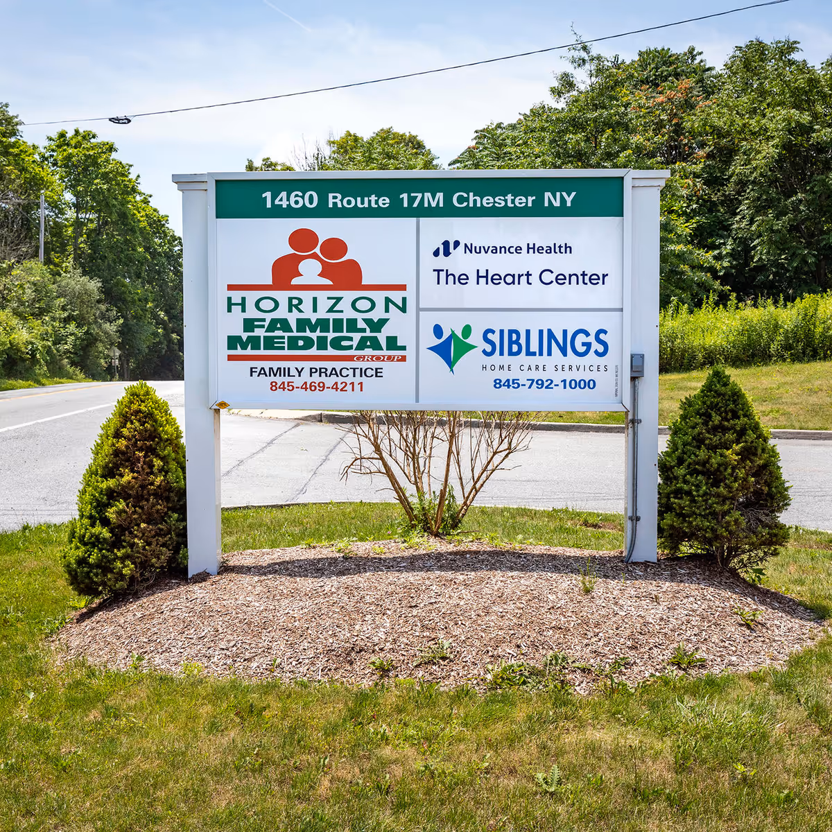 Outdoor sign shows The Heart Center and affiliated medical providers with address in Chester, NY.
