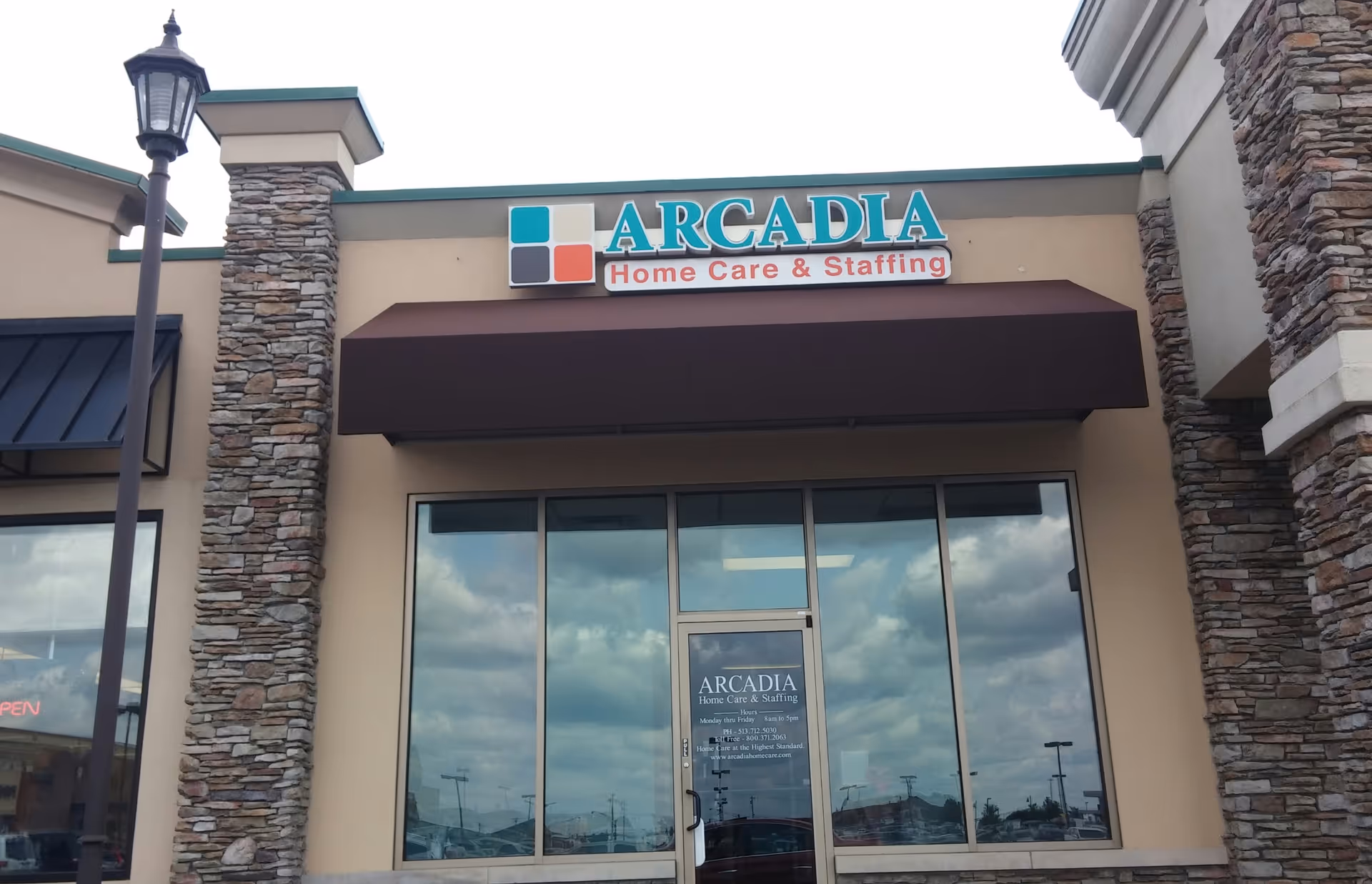 Exterior view of Arcadia Home Care & Staffing storefront with glass doors.