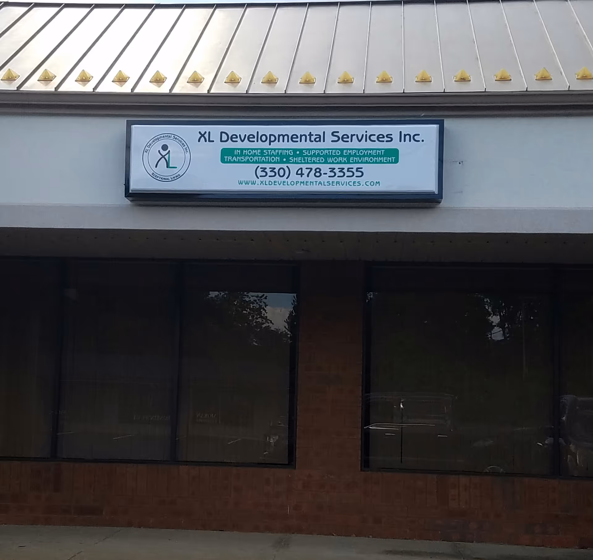 Exterior view of a building storefront with a sign for XL Developmental Services Inc.