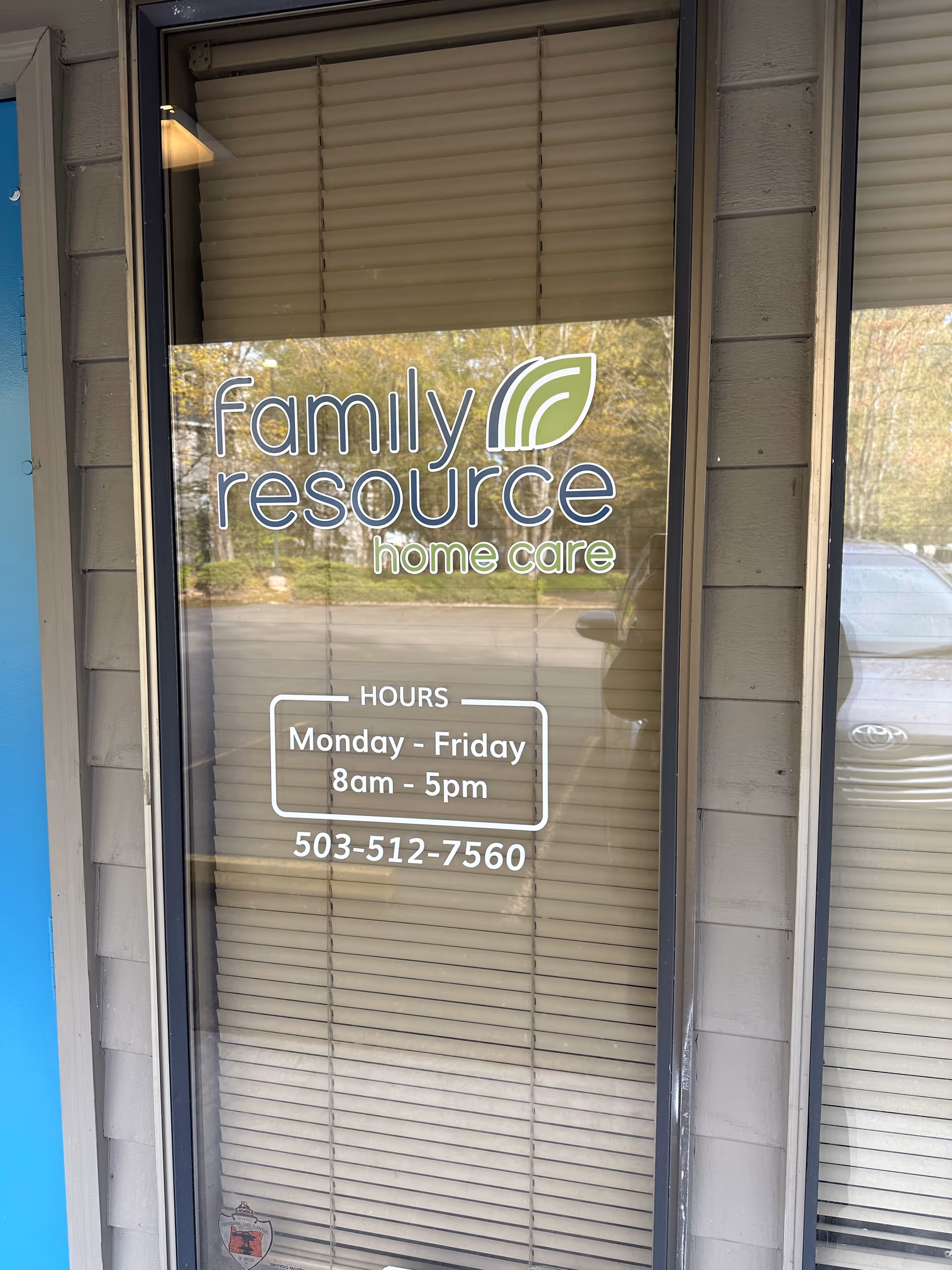 Exterior glass door displays Family Resource Home Care logo, hours, and phone number.