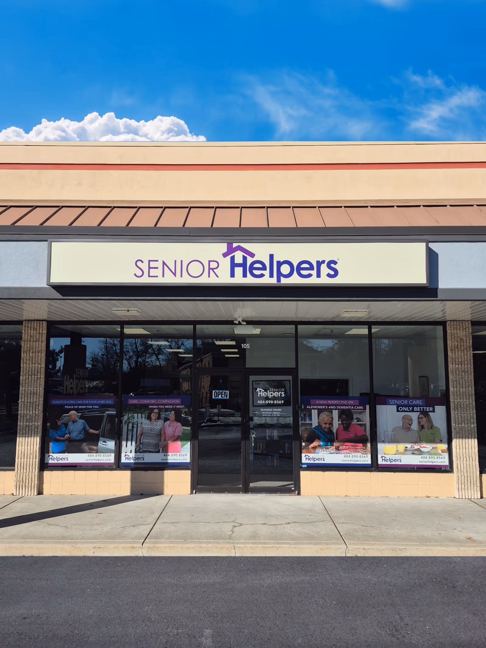 Storefront of Senior Helpers with large sign, glass entrance, and posters in windows.