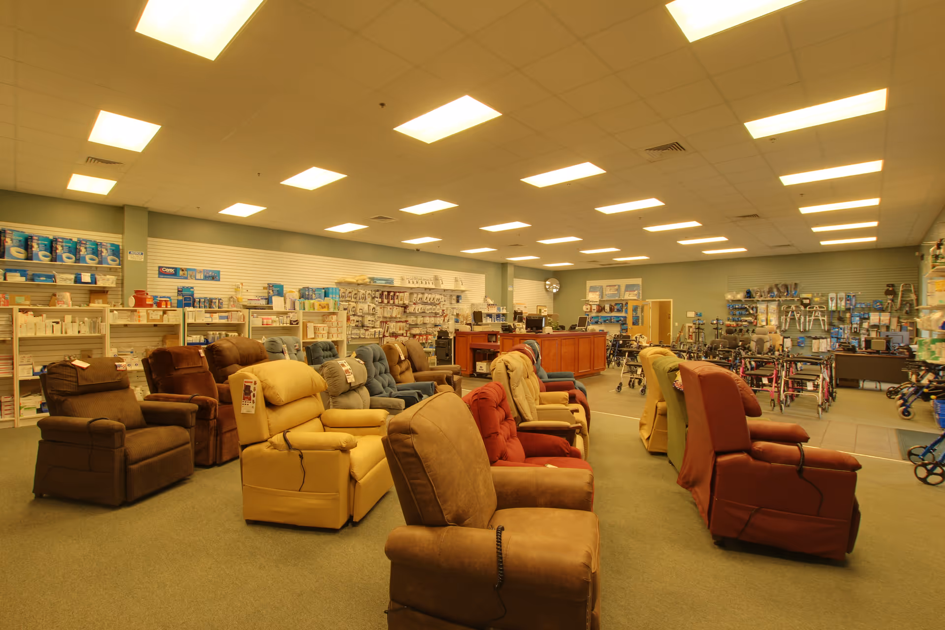 Large interior showroom with rows of recliner chairs and healthcare supplies on shelves.