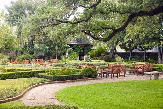 Outdoor garden courtyard at Houston Hospice with benches and trees.