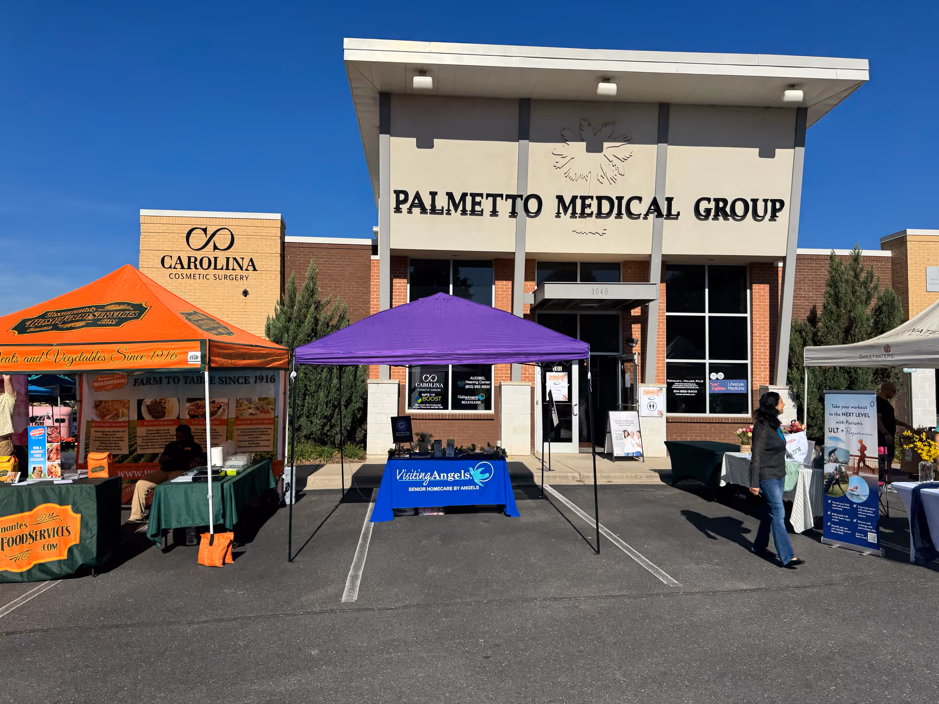 Exterior view of Palmetto Medical Group building with Visiting Angels tents outside.