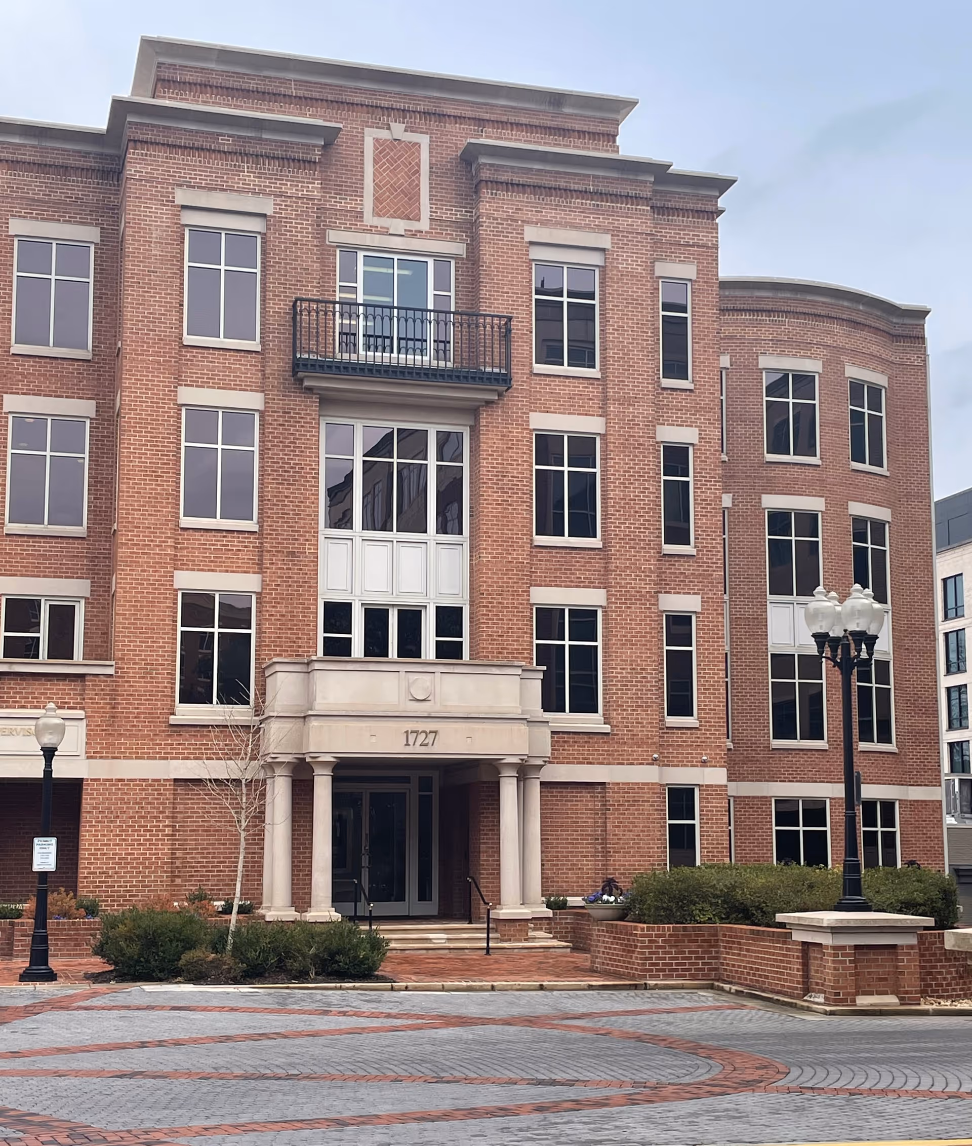 Exterior view of a BrightStar Care building with brick façade and columns.