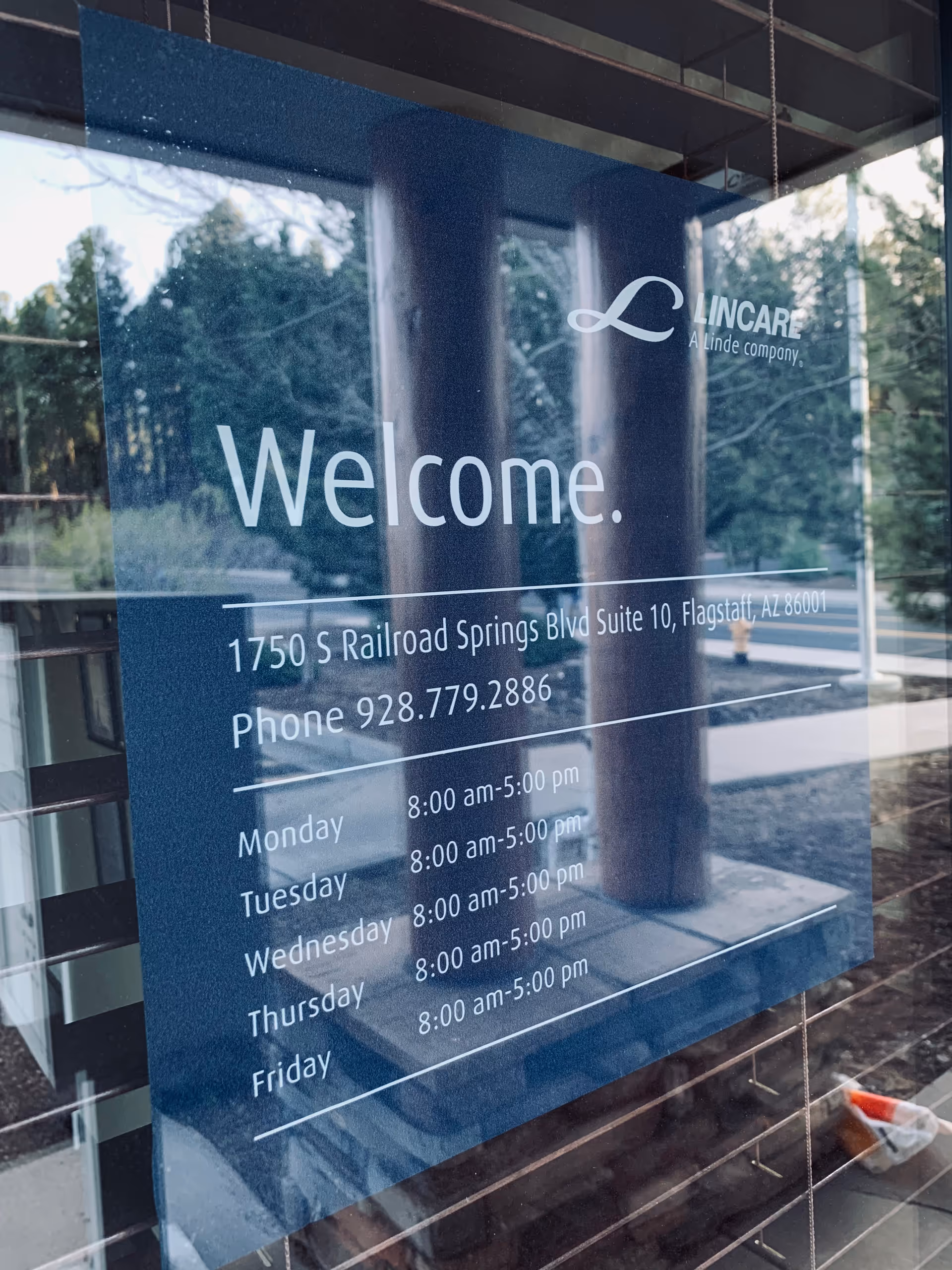 A glass entrance sign displays 'Welcome' and LINCARE information at the facility front.